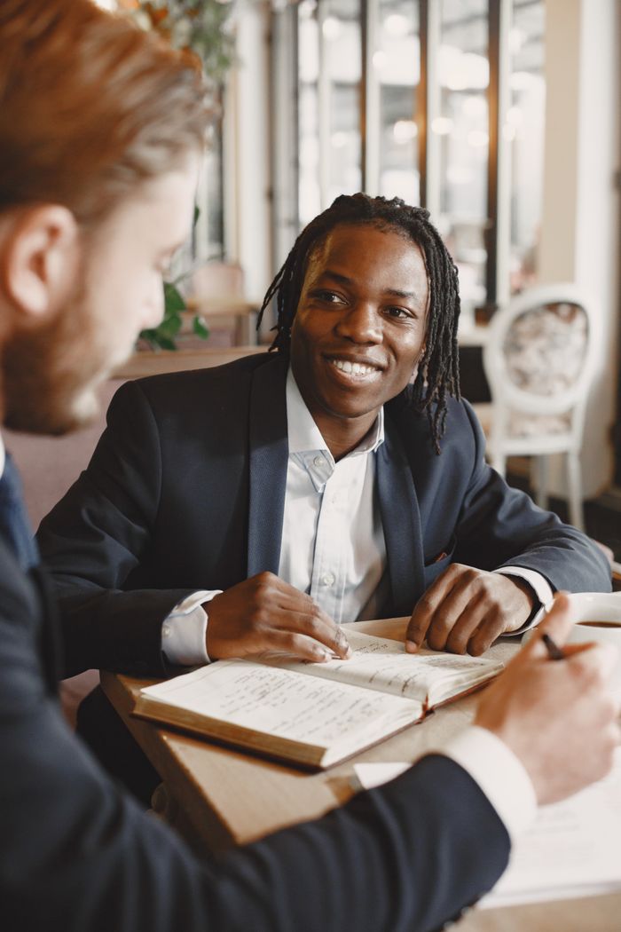 Two businessmen engaged in a productive meeting at a modern office table.