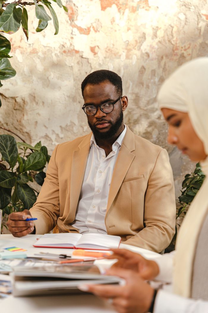A business meeting with diverse professionals collaborating on projects at a table.